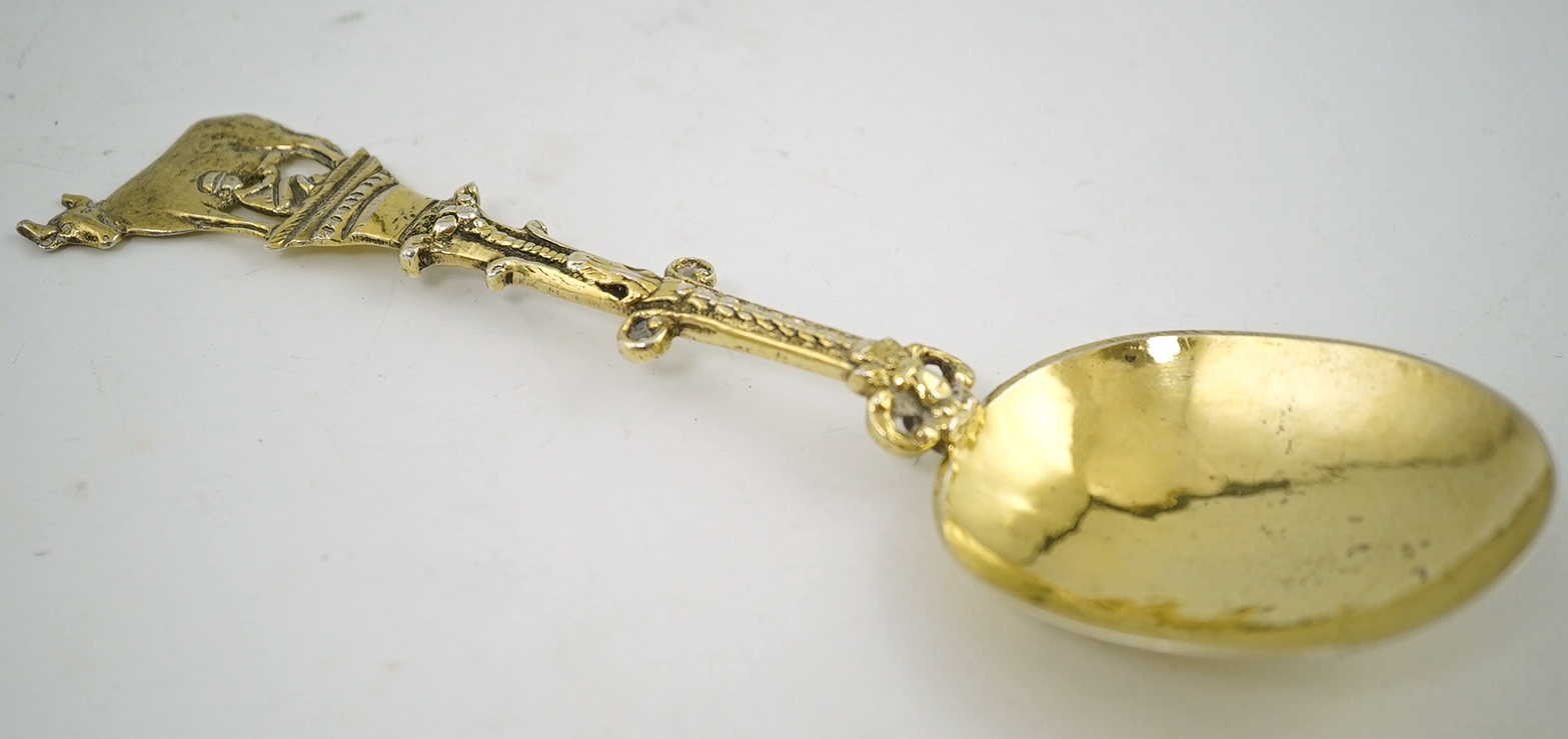 An early 17th century Dutch silver gilt spoon, the terminal modelled as a cow being milked, 17.5cm long, 47g. Condition - fair